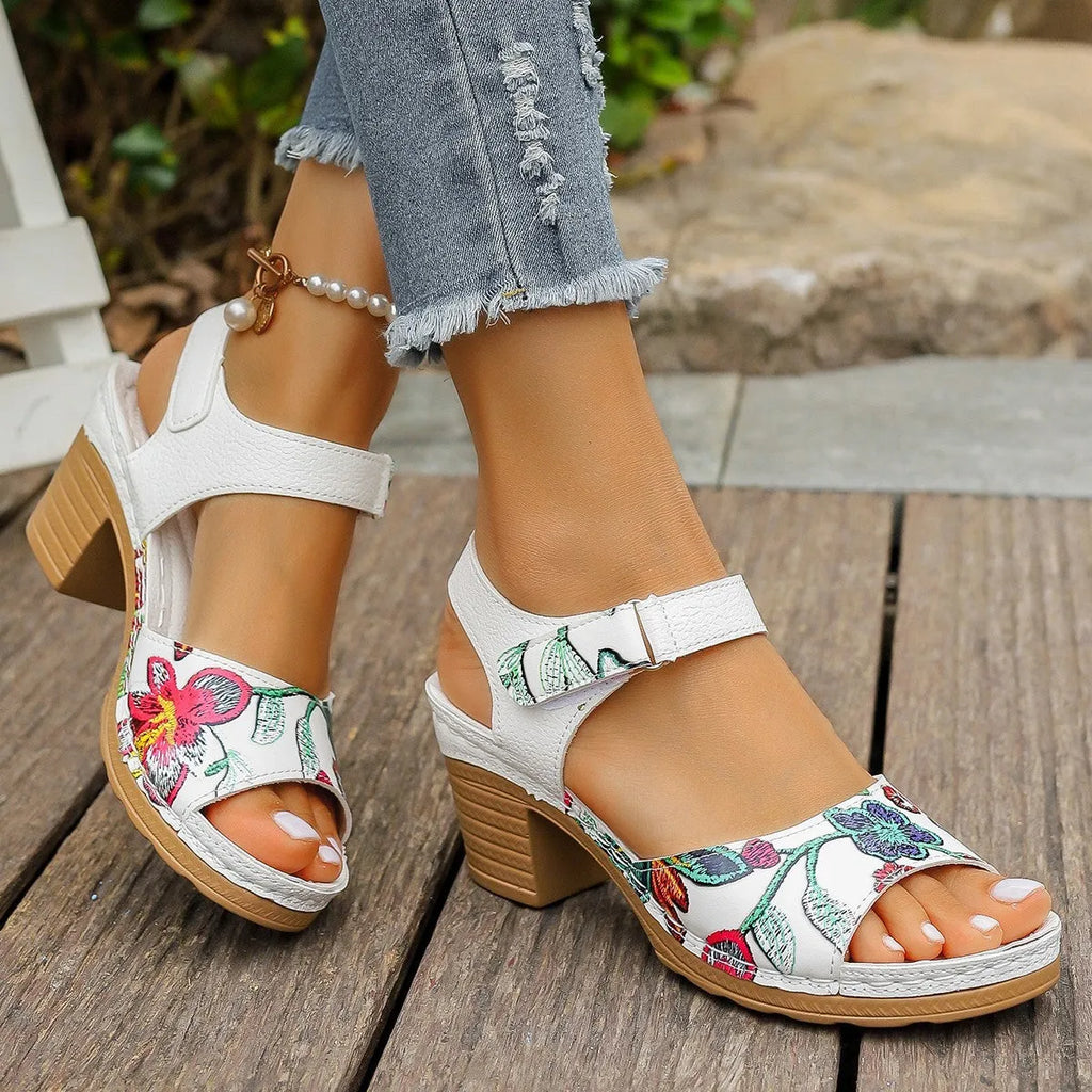 White women's high heel sandals with a Velcro buckle strap and a rubber sole.