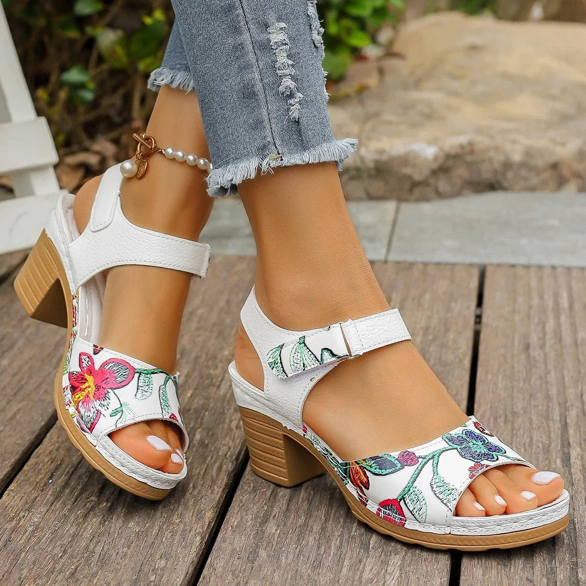 White women's high heel sandals with a Velcro buckle strap and a rubber sole.