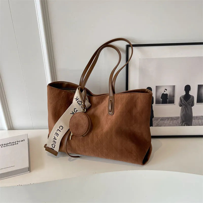 Soft polyester large tote shoulder bag in a horizontal square shape with an external pocket.