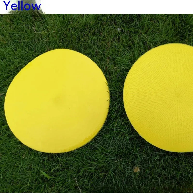 Soft yellow TPE football training landmark pad on grass, showing 23cm diameter.