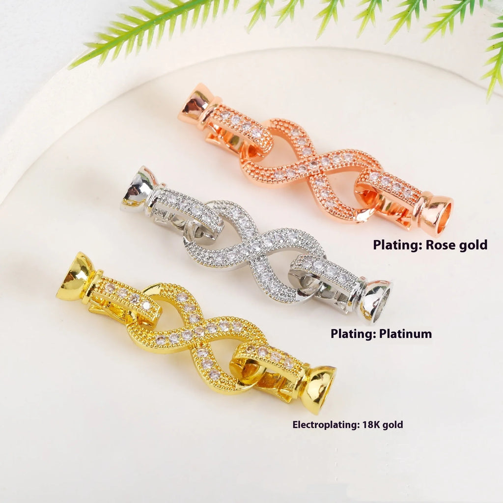 Small gold colour metal chain buckle for DIY necklace making on a white background.