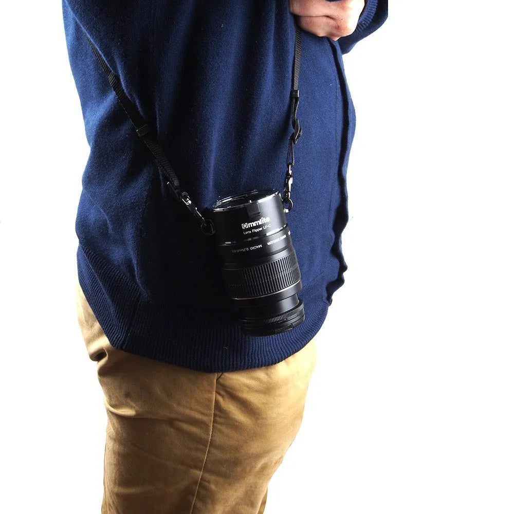 Aluminium camera lens flipper holder for Nikon with cotton shoulder strap.