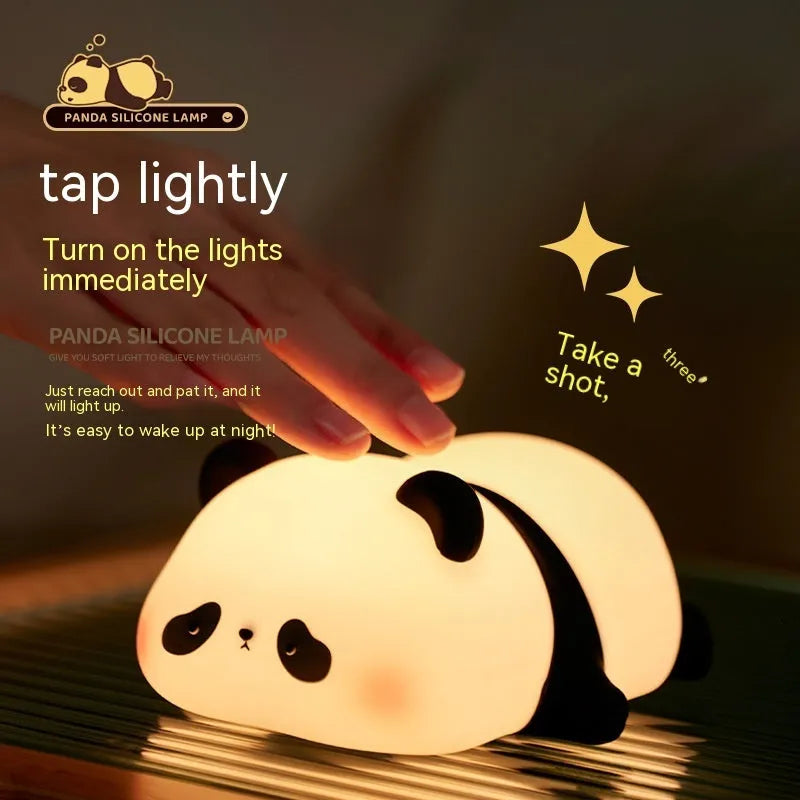 Panda shaped silicone night light with warm white glow on dark surface