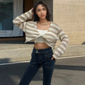 Women's black and white striped cropped long sleeve sweater made from mercerised cotton on a model.