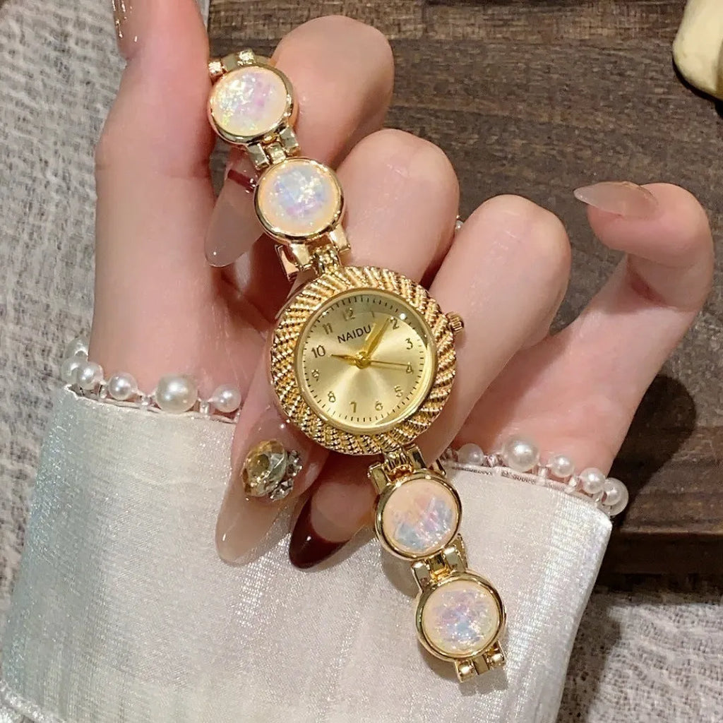 Women's quartz watch with 25mm round dial and zinc alloy case in milky white colour.