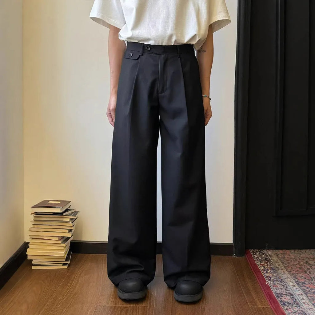 Man wearing straight-leg loose fit casual trousers in brown, showcasing the drape and fit.