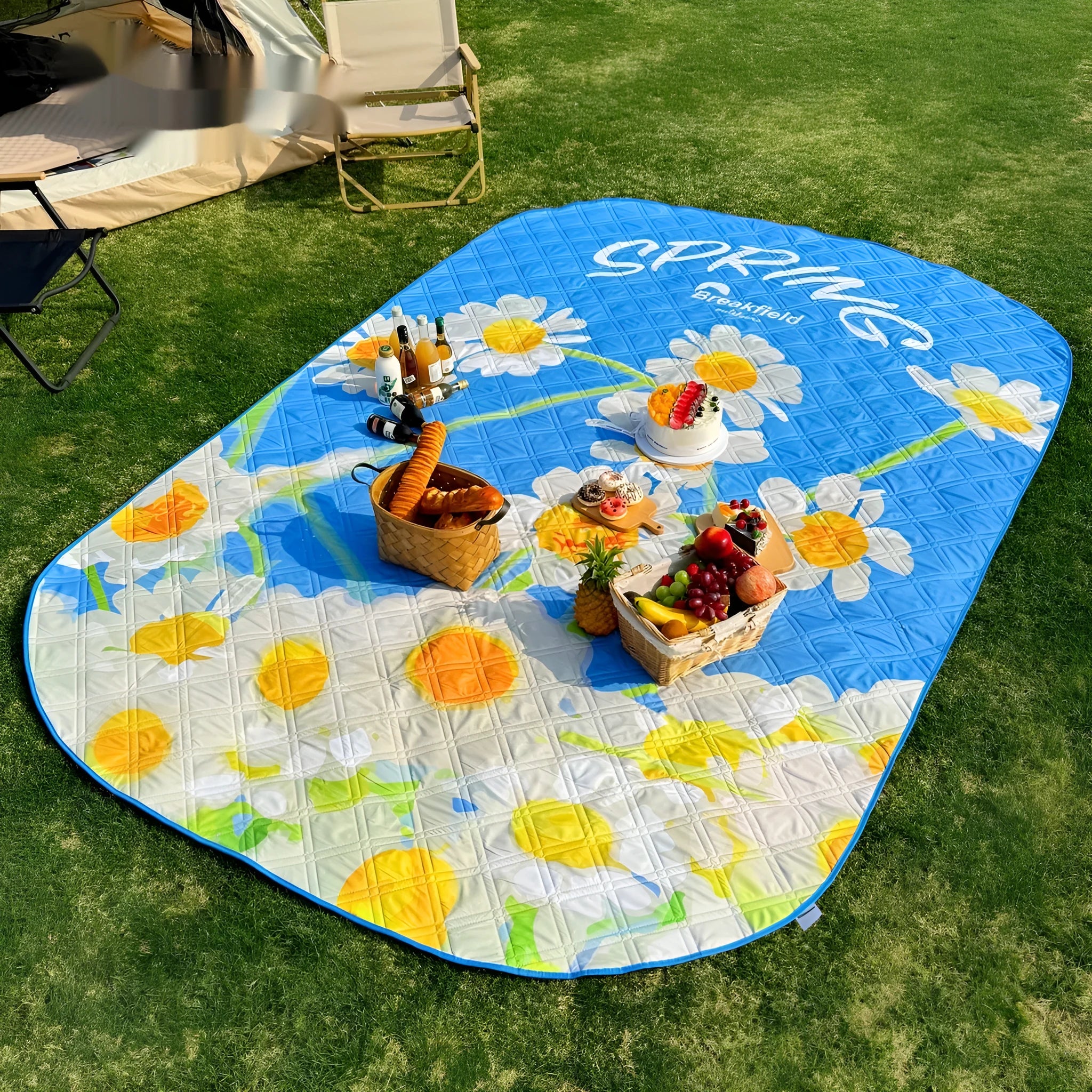 Waterproof thickened picnic mat in a Four Seasons colour, shown unrolled on grass.