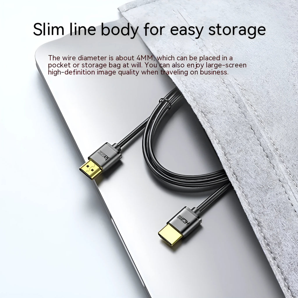 Thin flexible HDMI video cable with gold-plated connectors on a white background.