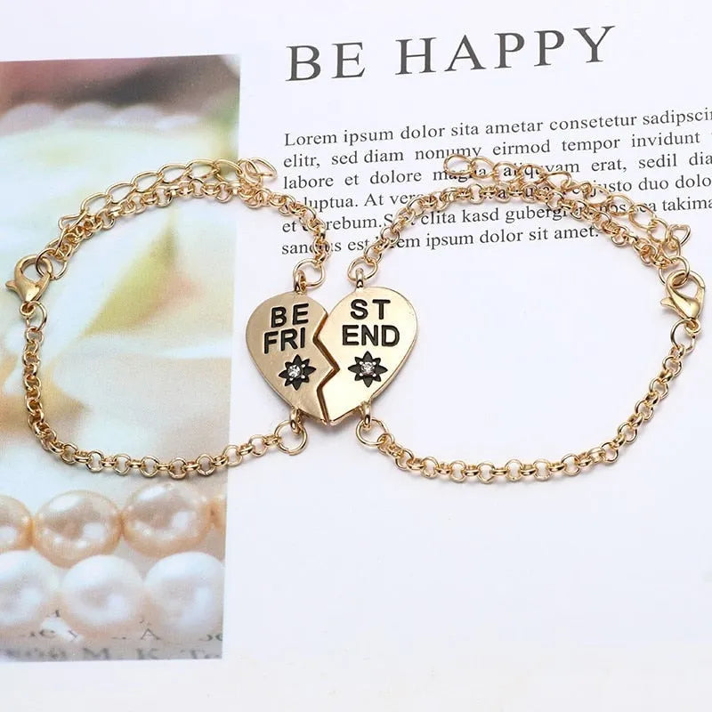 Heart shape alloy bracelet with dripping oil finish and inlaid gems in gold and silver colours