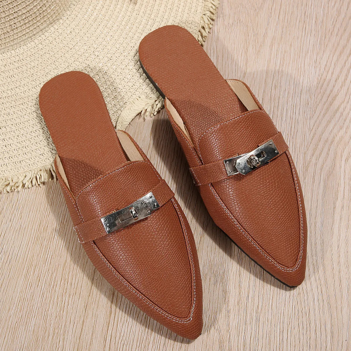 Light brown women's pointed-toe casual slippers with a low heel and rubber sole.
