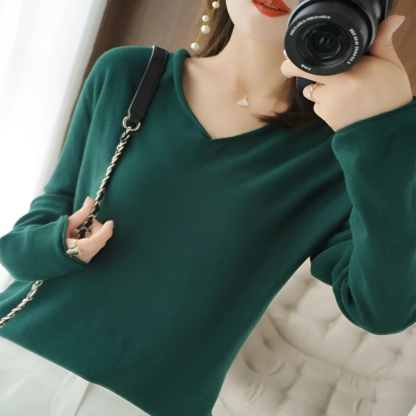 Women's V-neck long sleeve knitwear pullover top in a macaron colour on a hanger.