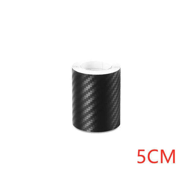 Matte black 3D carbon fibre adhesive protection roll for car door sills in various widths.