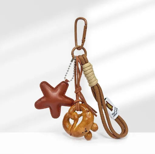 Handmade soda bread style handbag pendant charm with cartoon design and brown strap