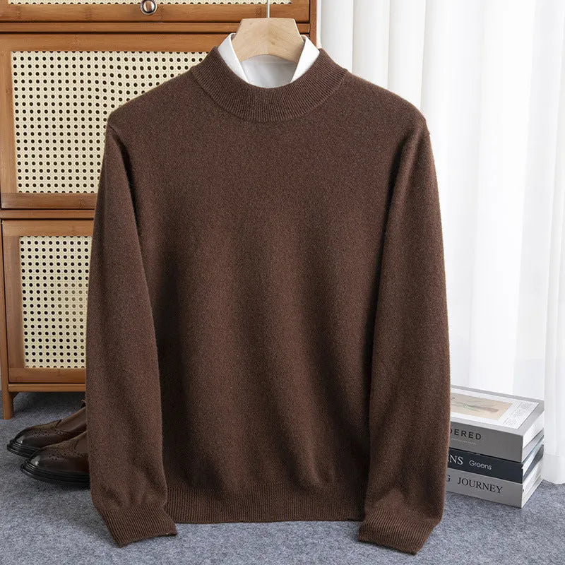 Man wearing a loose-fit, chunky knit wool sweater with a half-turtleneck collar in a neutral colour.