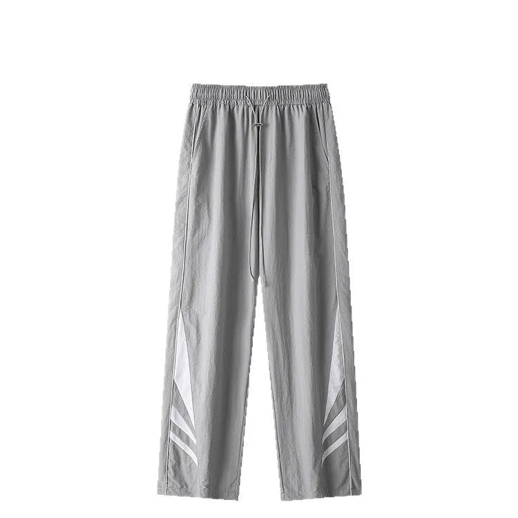 Men's straight leg summer sports trousers in grey, showing loose fit and button fly.