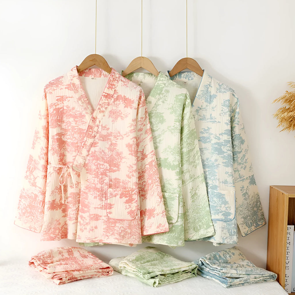 Women's pink cotton gauze long sleeve top and trousers matching loungewear set laid flat.