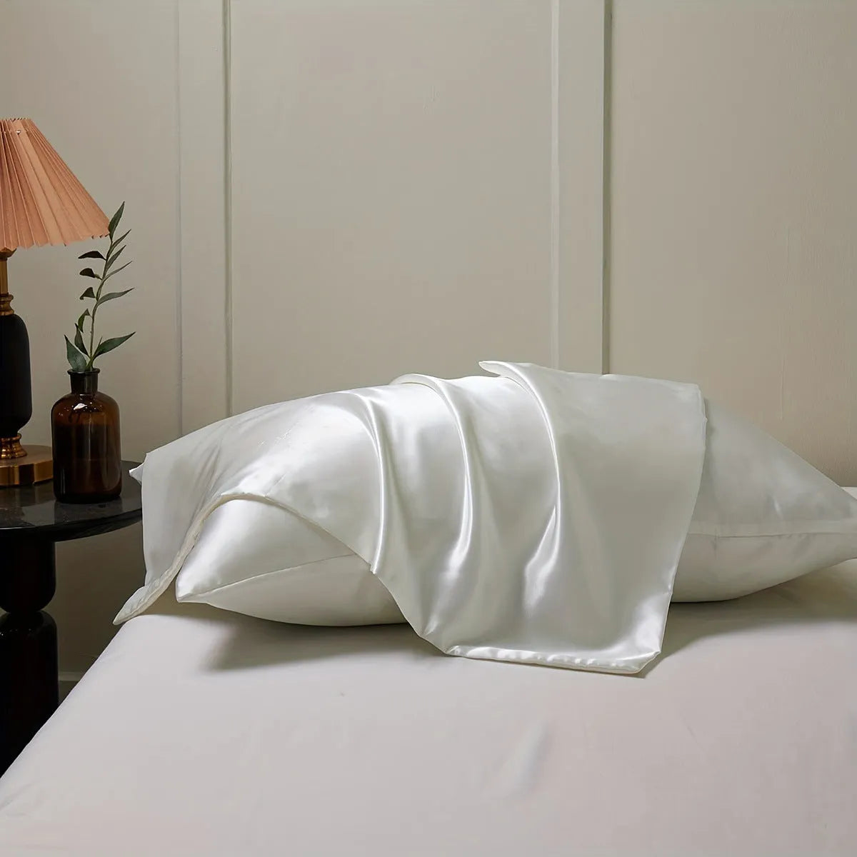 A pair of solid colour satin pillowcases in a chosen shade, showing the smooth plain weave fabric texture.