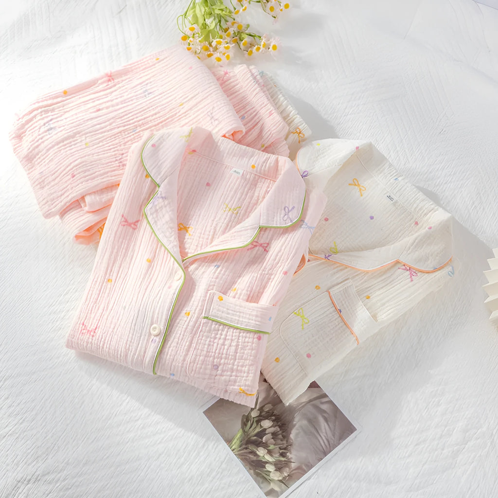 Beige and pink women's long-sleeved cotton pajama set with trousers on a hanger.