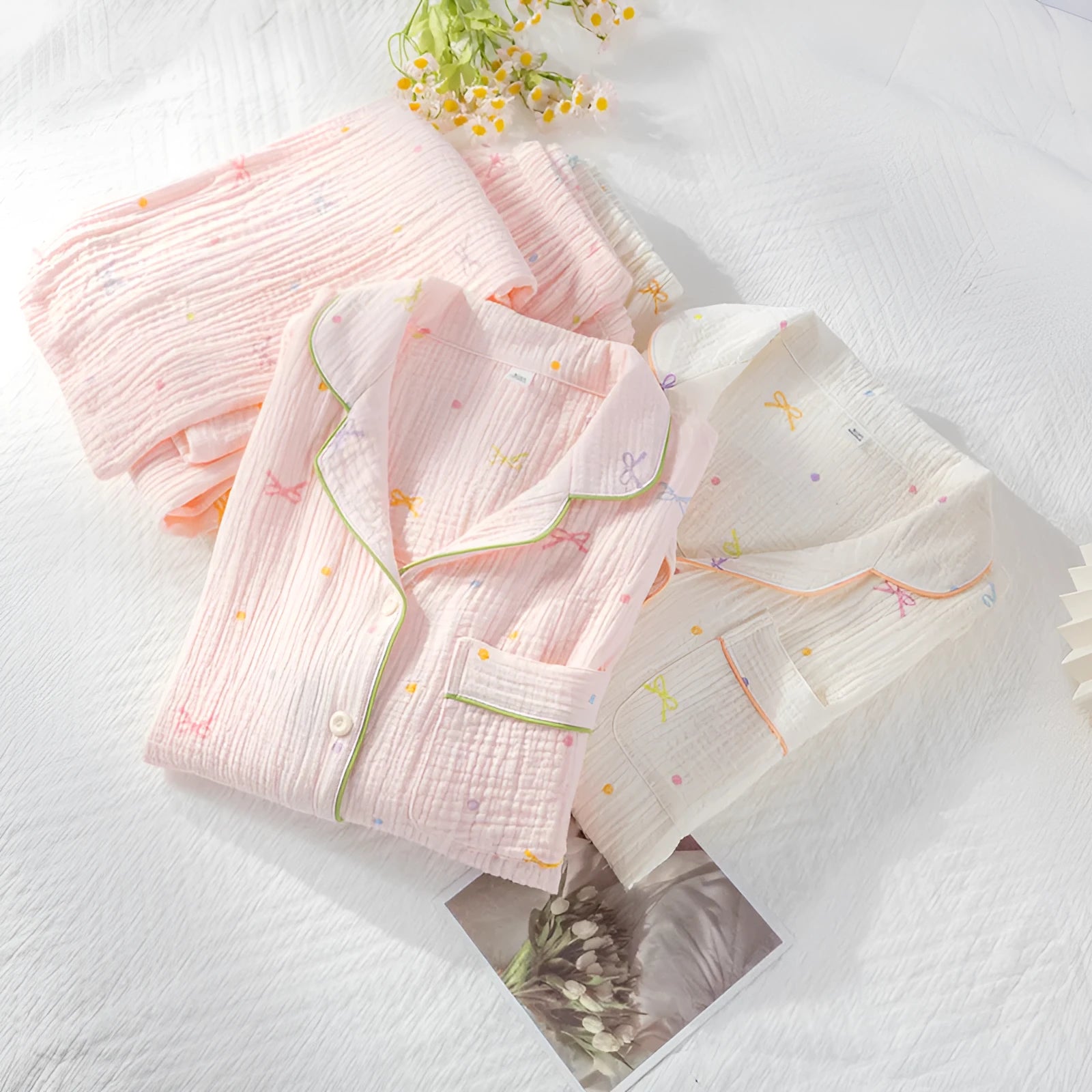 Beige and pink women's long-sleeved cotton pajama set with trousers on a hanger.