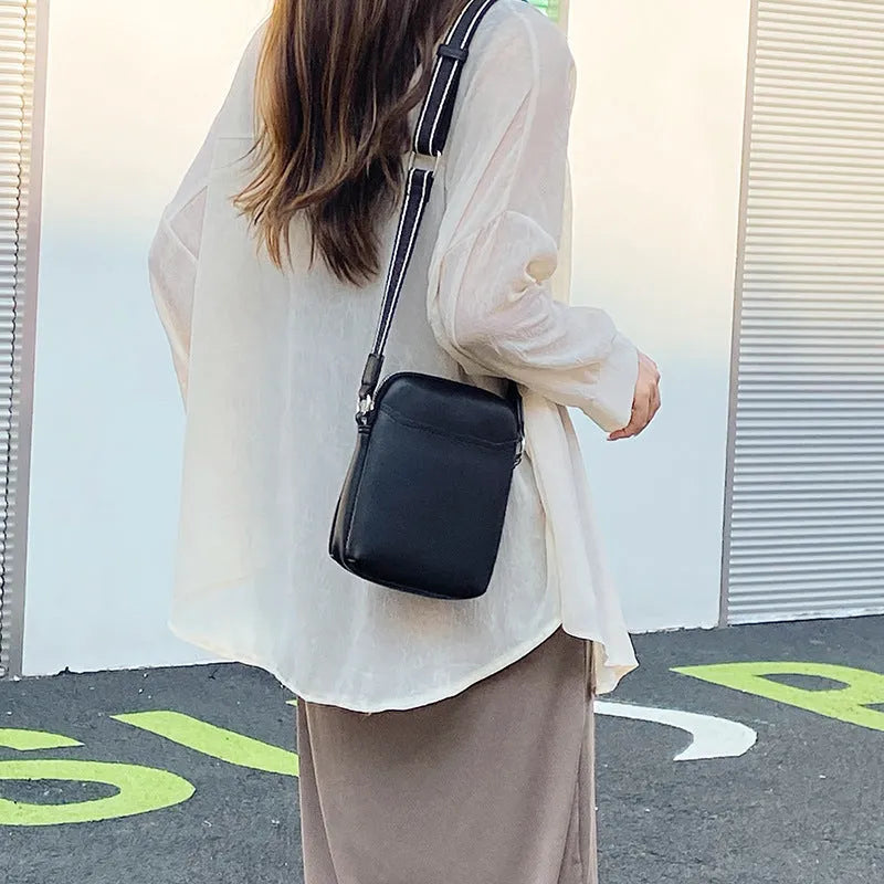 Solid colour small crossbody shoulder bag in PU leather measuring 14.5cm by 5.5cm by 19cm