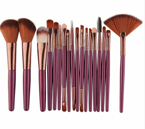 MAANGE 18-piece makeup brush set with fan-shaped cosmetic tools laid out on a table.