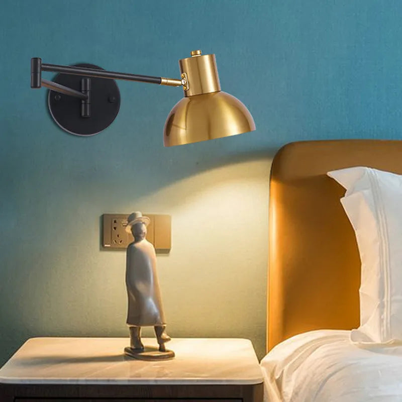 Modern double-section rocker arm wall lamp with adjustable arms on a white wall.