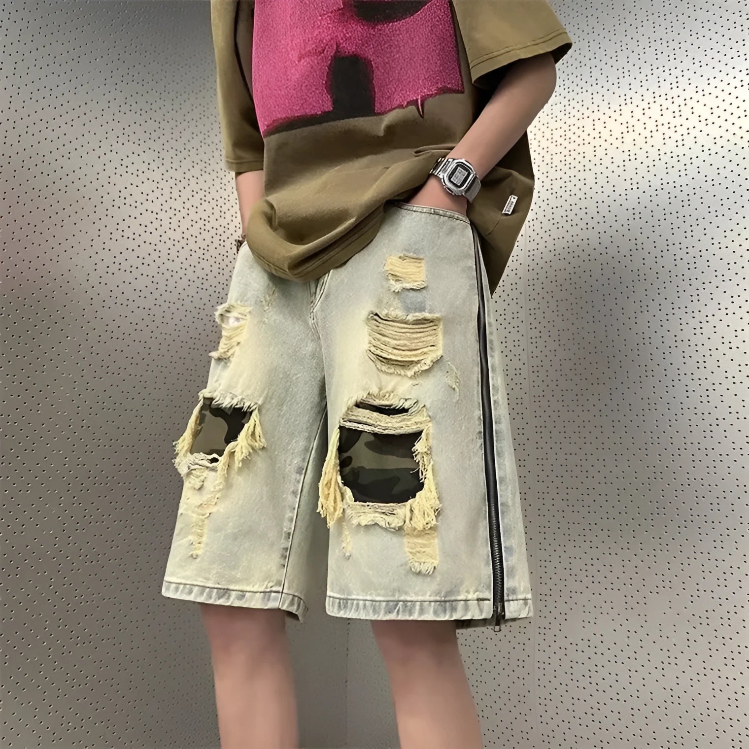Men's yellow mud camouflage ripped denim shorts shown on a model, featuring a straight leg cut and distressed details.