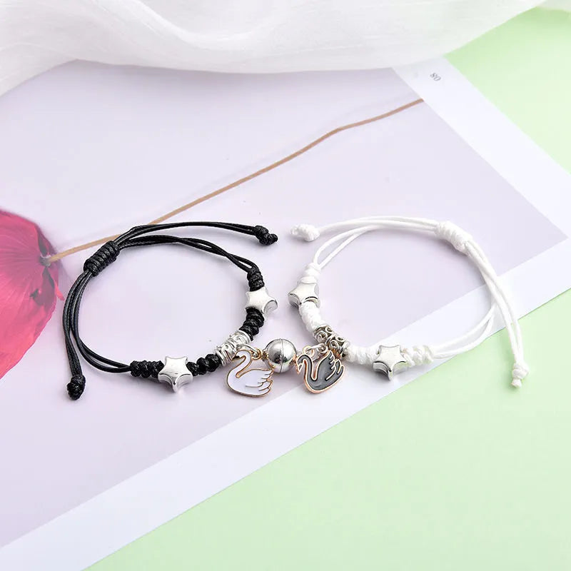 Magnetic couple bracelet pair with alloy electroplating in various designs including clover and crown patterns