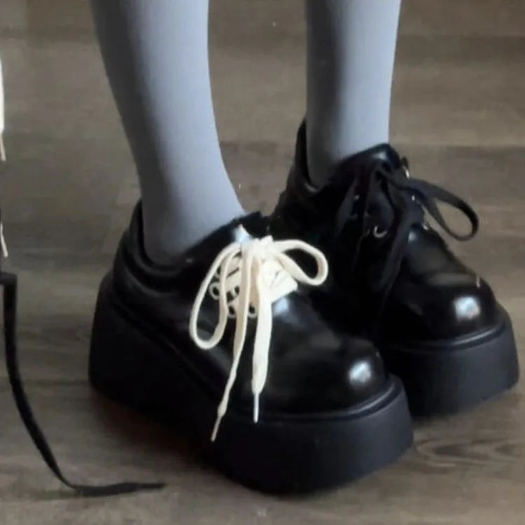 Women's matte black lace-up shoes with a chunky 6-8cm heel and thick rubber sole.