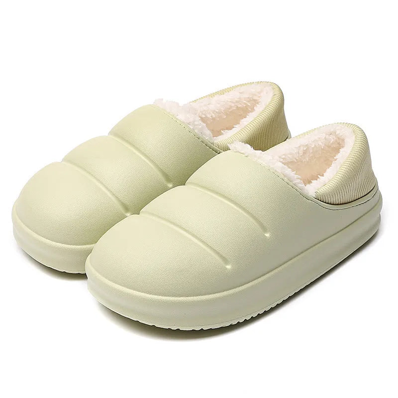 Green EVA waterproof garden slippers with non-slip sole and plush lining shown on wooden decking