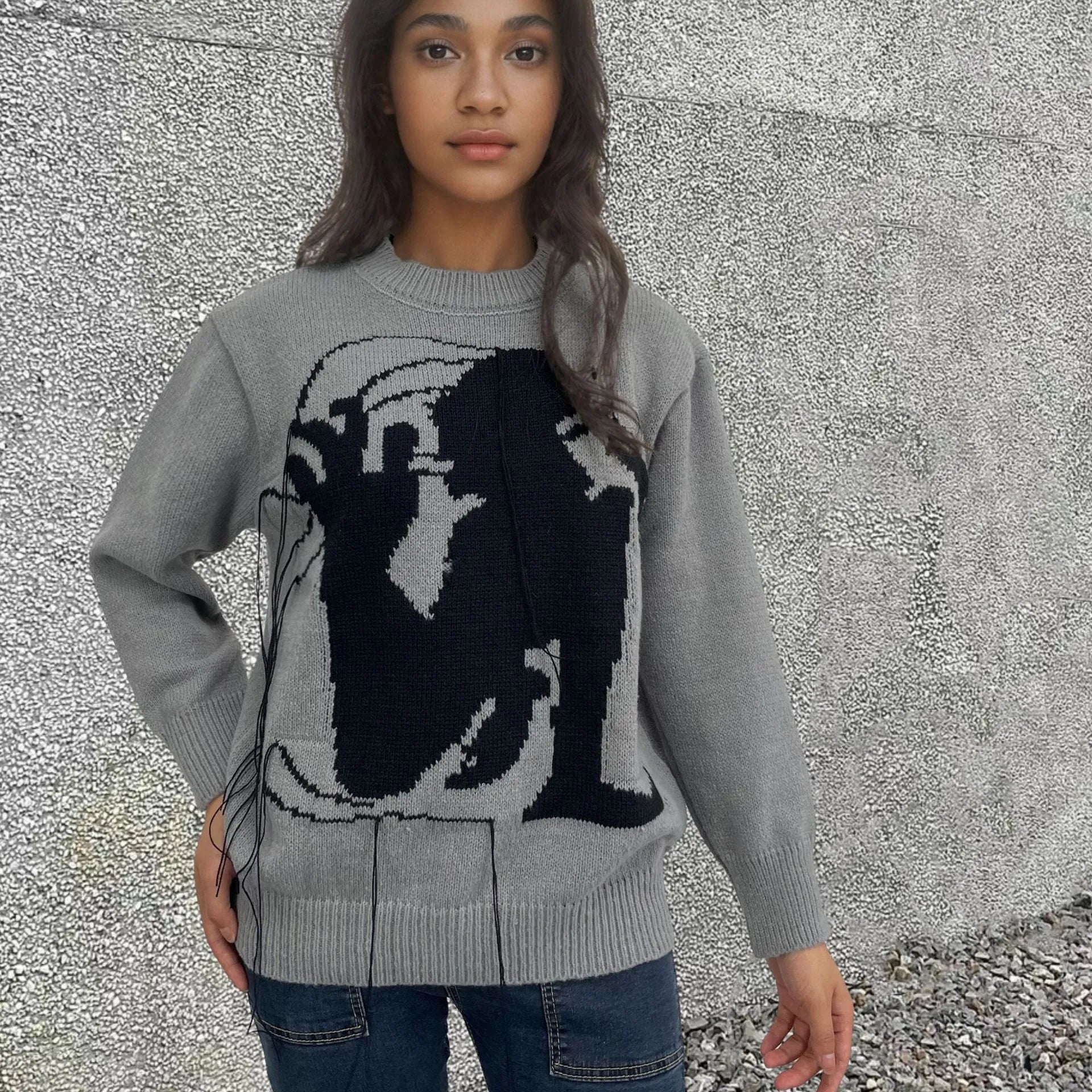 Grey alpaca wool women's sweater with abstract pattern and tassel detail on sleeve.