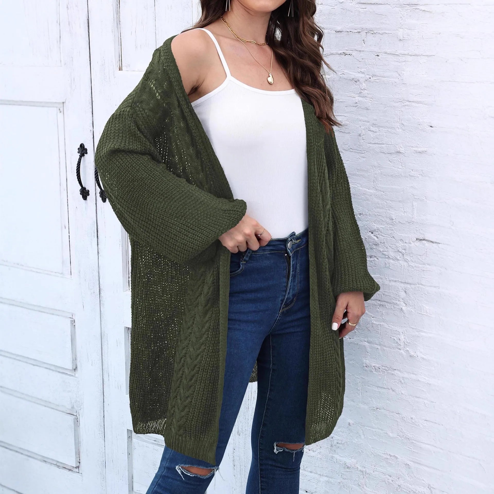 Women's loose acrylic sweater coat in army green, shown as a layering piece.