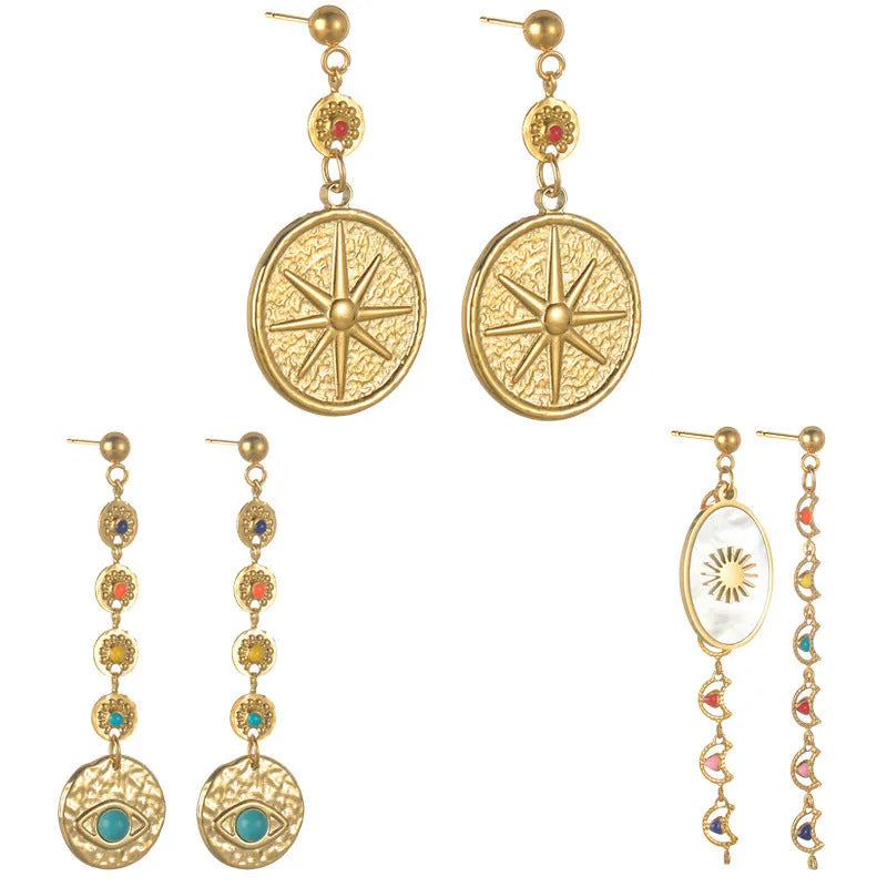 Geometric stainless steel earrings showing eight-point star, eye symbol, and shell sun designs