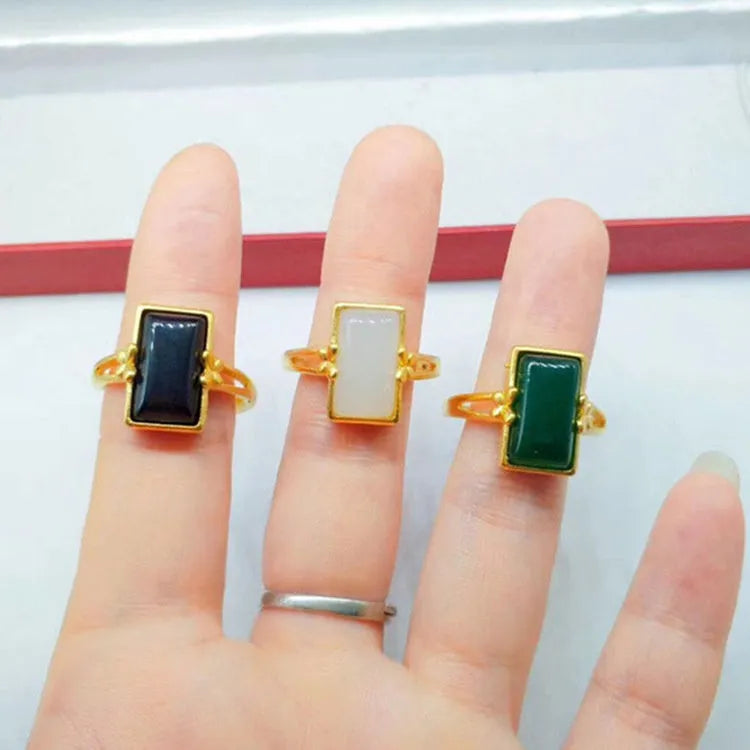 Adjustable brass gold-plated ring with gemstone in green, white or black options showing adjustable port mechanism
