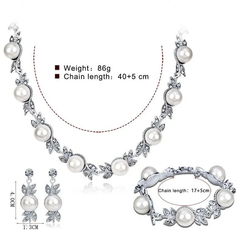 Three-piece jewellery set with rhinestone and pearl necklace, earrings, and bracelet in silver finish
