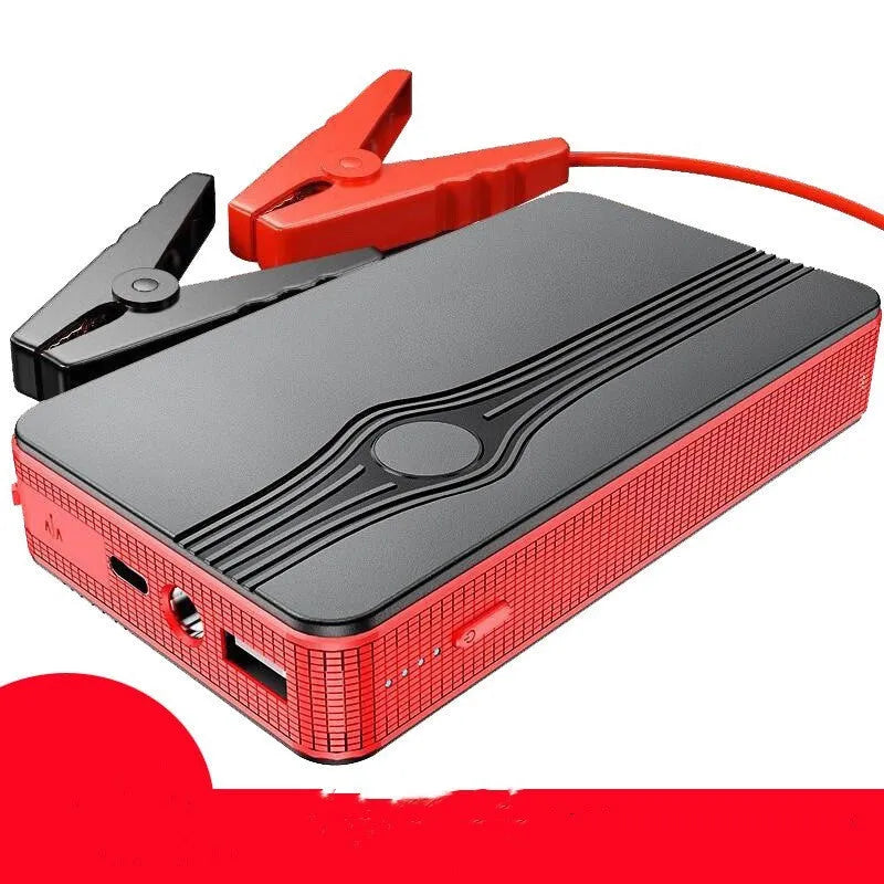 Red K4-E automobile emergency starting power supply and USB power bank unit on a grey surface.