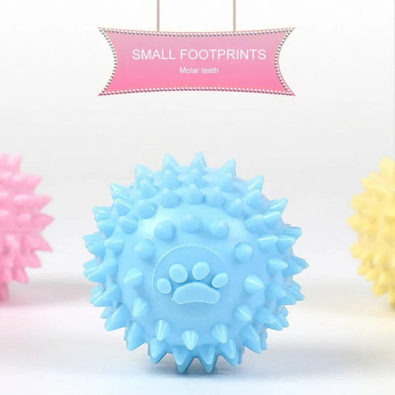 Blue, pink, or yellow TPR dog chewing ball with textured sides for tooth cleaning
