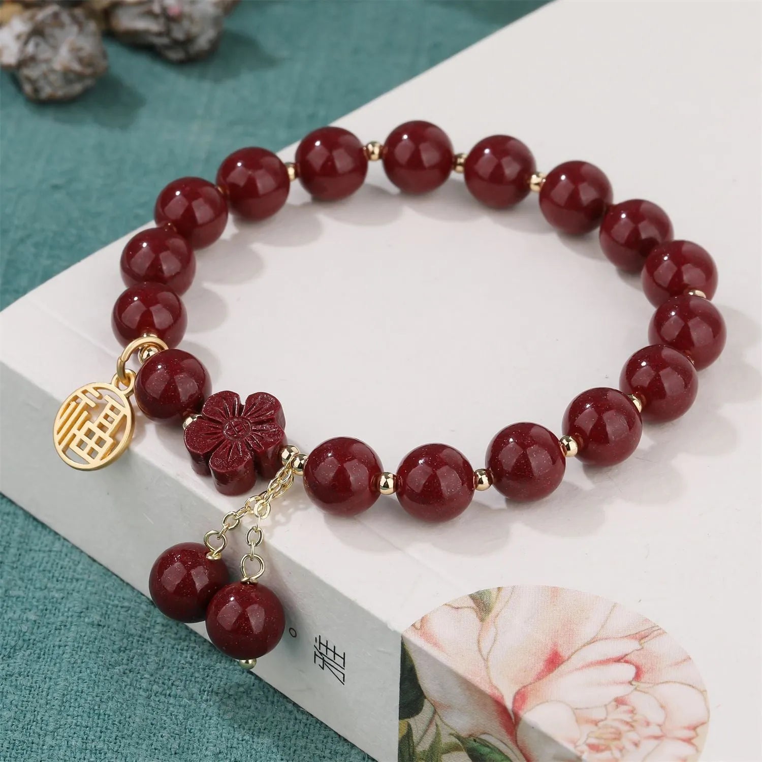 Women's cinnabar bracelet with fu character charm in purple gold sand colour and peach blossom detailing