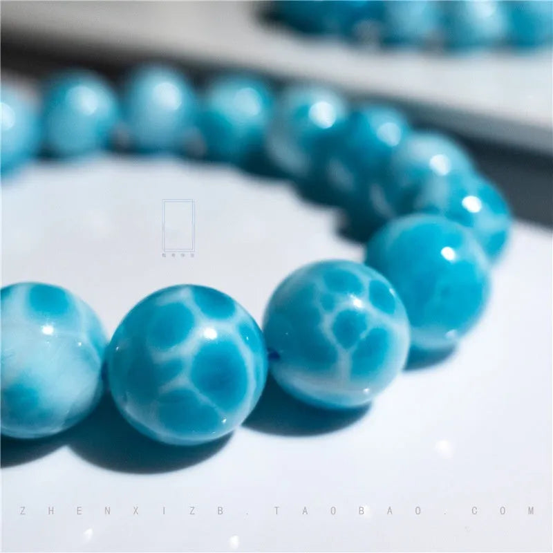 Blue Bodhi bracelet with sea-pattern crystal beads and pearl accents in Maillard style on wrist