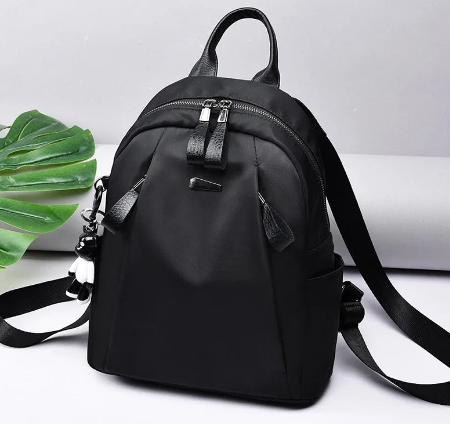 Medium square Oxford cloth rucksack in black with double straps and a front digging bag.