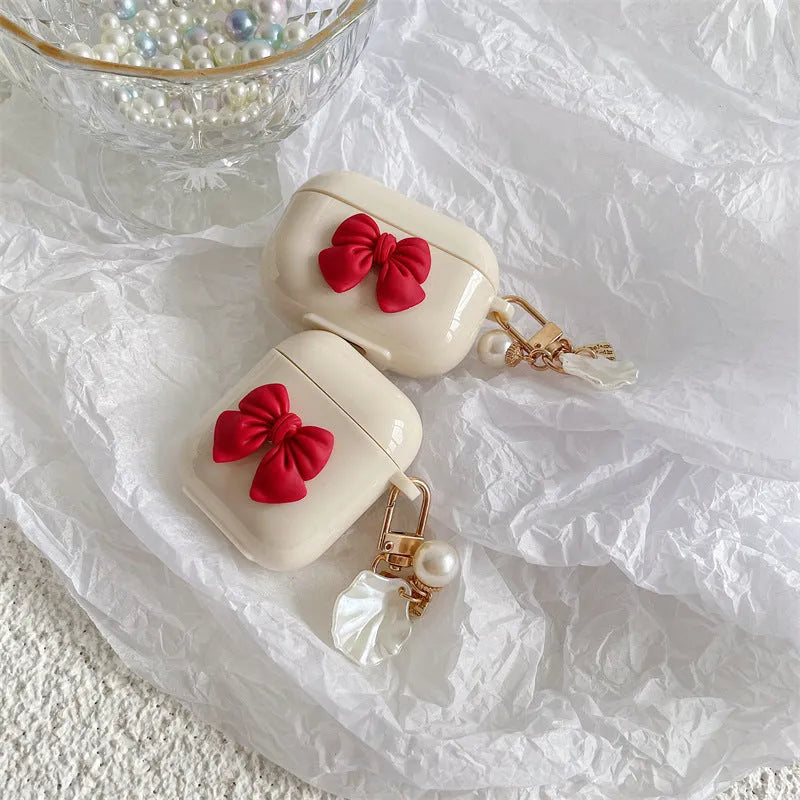 Beige and red bow shell design TPU silicone protective case for AirPods Pro charging case.