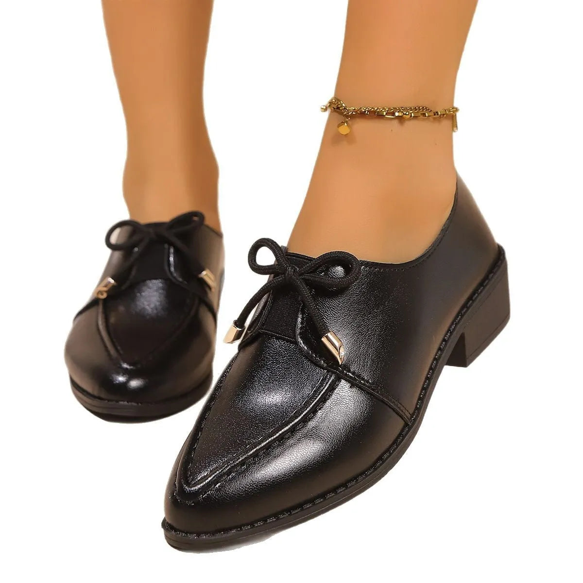 Women's British-style leather shoes with decorative bow detailing on pointed toe