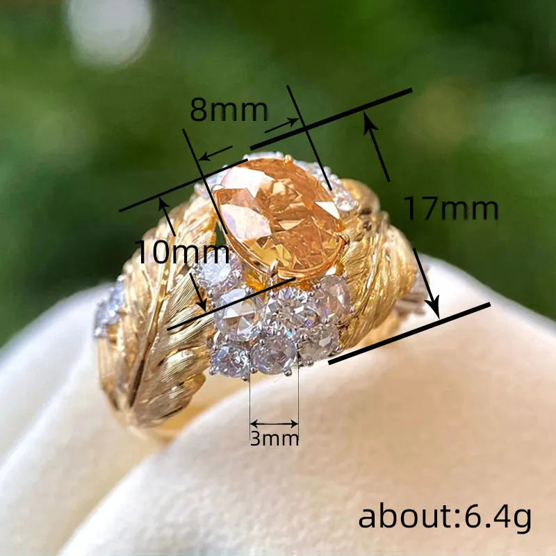 Gold-coloured embossed feather ring with geometric shape and zircon inlay, shown in women's fashion jewellery style