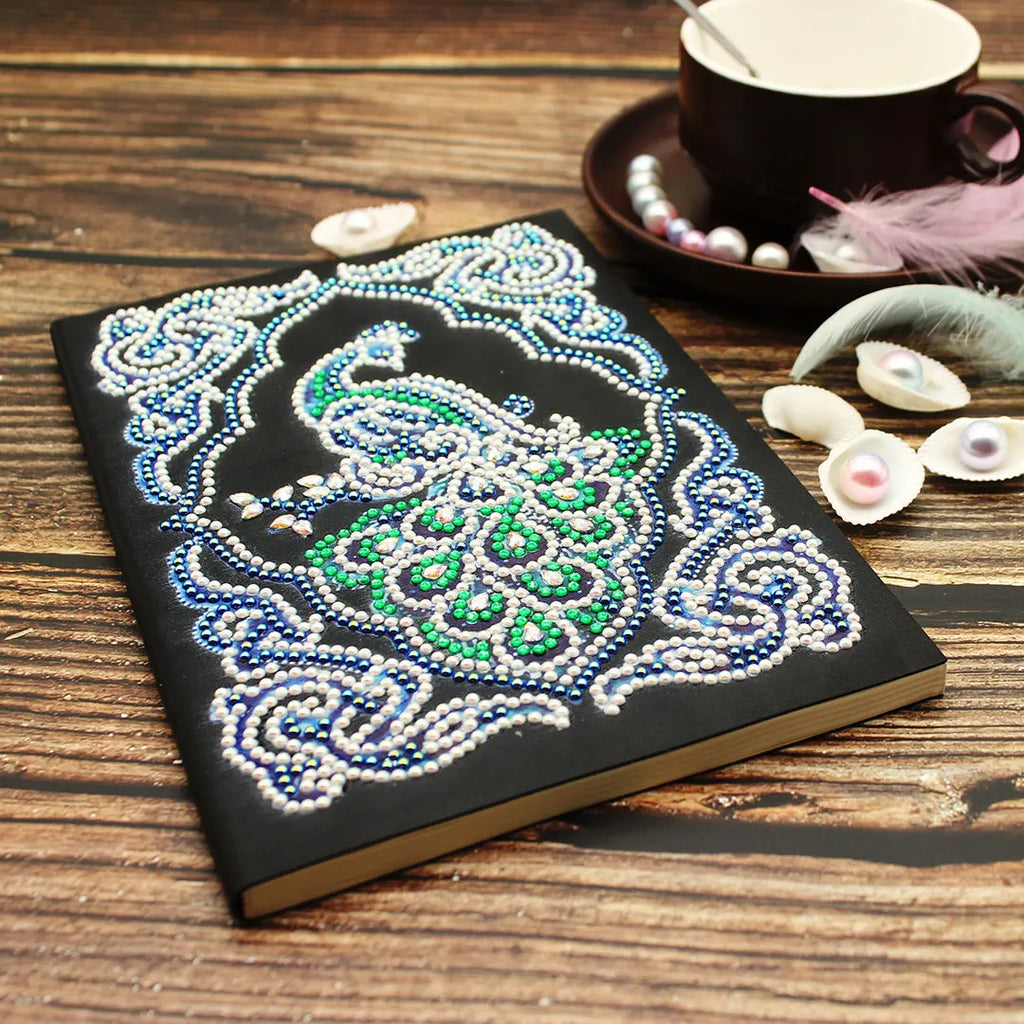 Black A5 diamond painting notebook with peacock design showing shaped and bright drills