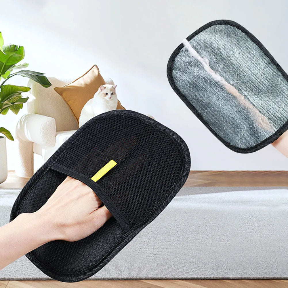 Black pet hair removal glove with silicone bristles, shown on a hand grooming a dog.