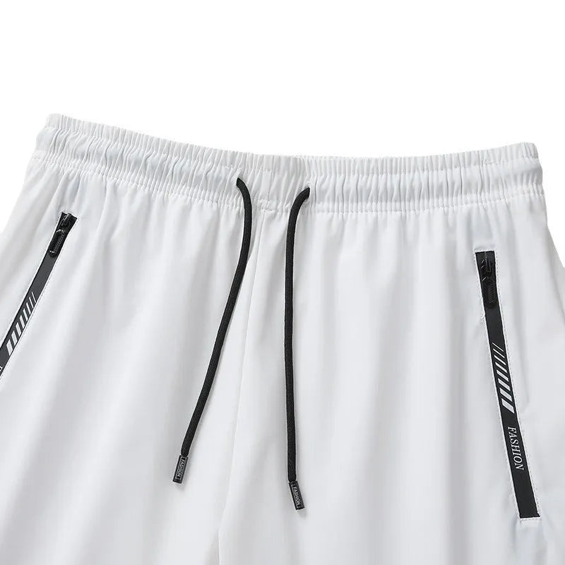 Men's black nylon quick-drying sports shorts with elastic waistband, shown in loose fit.