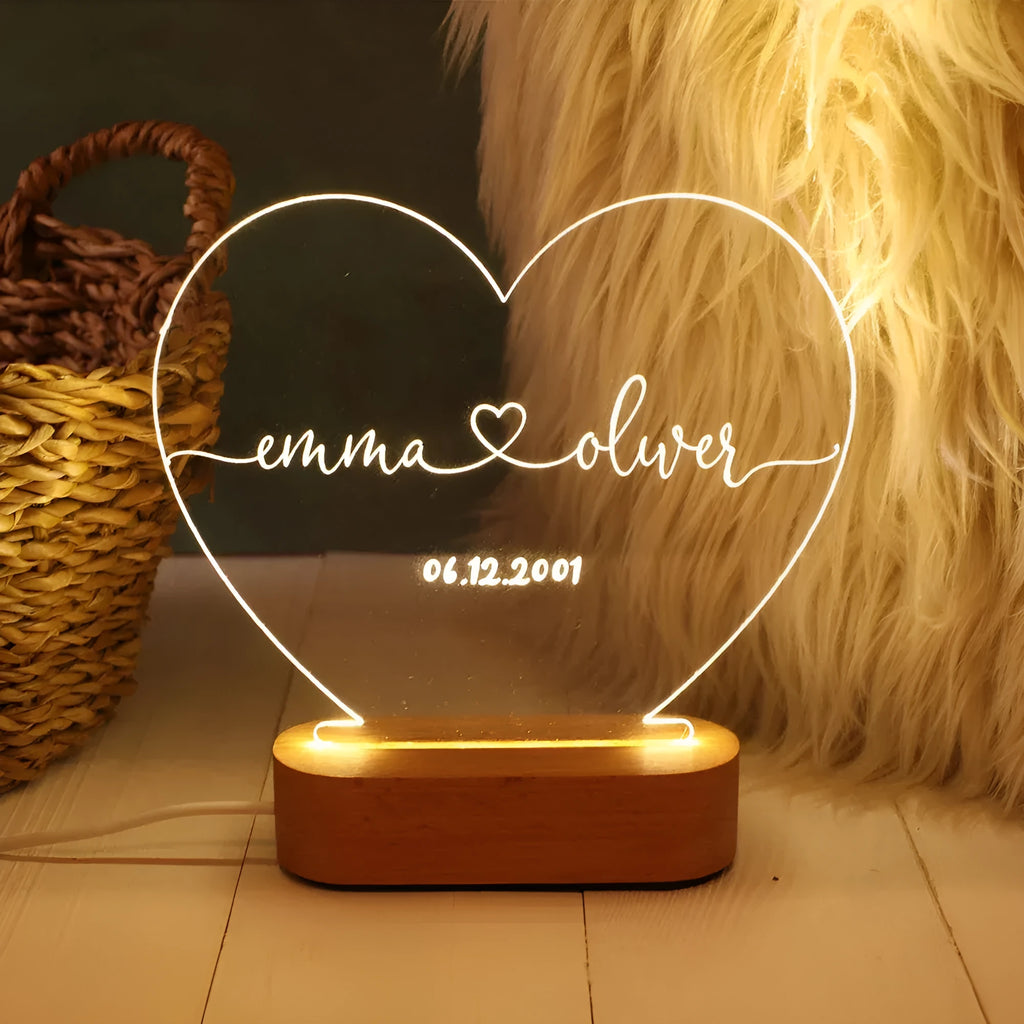 Custom engraved acrylic night light with LED base, showing personalised names and date.