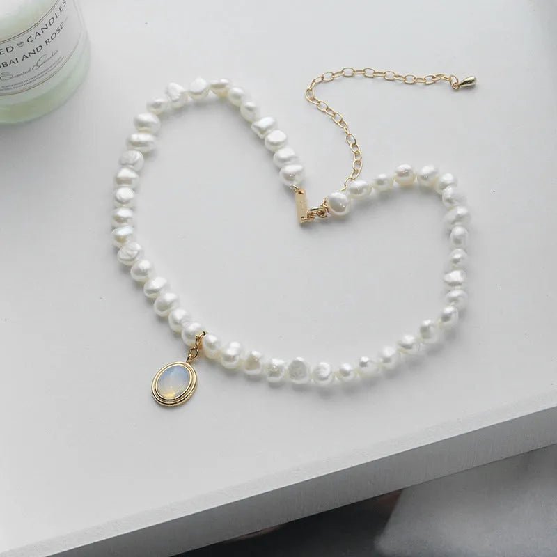 Round medal pearl necklace with geometric silver pendant and irregular freshwater pearls