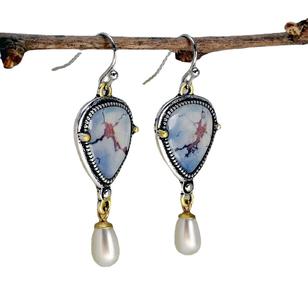 Retro blue geometric drop earrings with synthetic opal and white pearl details on electroplated metal.
