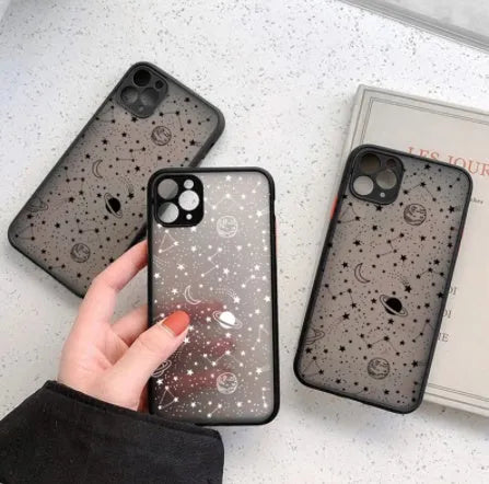 Black and white Star Universe anti-blue light phone case for iPhone models on a table.